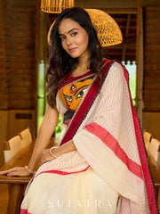 Striking white cotton saree with bold red-black borders, featuring a hand-painted Durga motif with Stitched Blouse